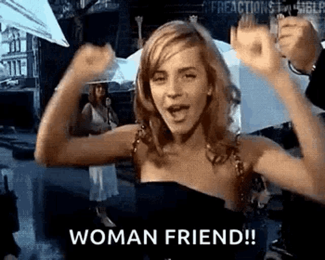 a woman in a black dress is flexing her muscles and saying woman friend !