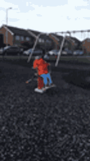 a blurry picture of a person riding a swing set in a park
