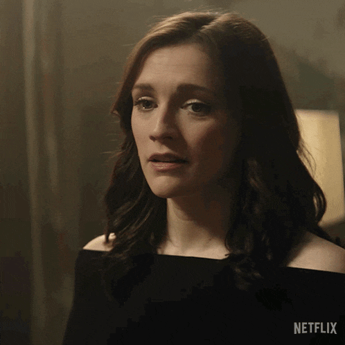a close up of a woman 's face with a netflix logo behind her