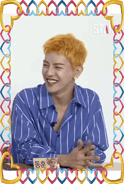 a man in a blue and white striped shirt is smiling in a frame that says star