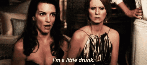 two women are sitting next to each other and one of them is talking about being a little drunk .