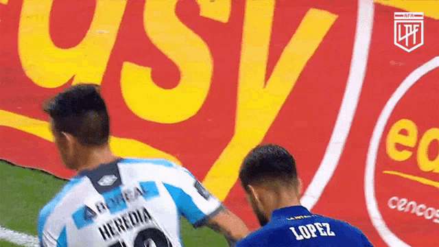 a soccer player wearing a blue jersey with the name lopez on it