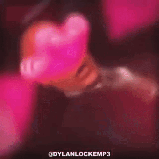 a man in a suit and tie is wearing heart shaped glasses