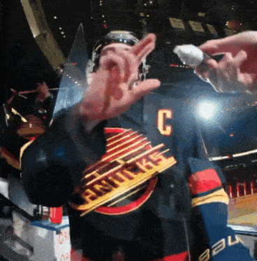 a hockey player wearing a jersey that says vancouver