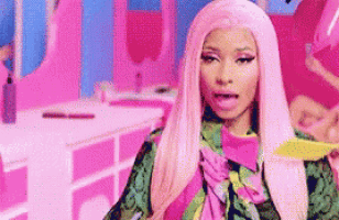 a woman with pink hair is standing in a pink room holding a yellow object .