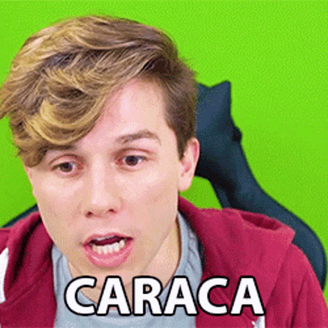a man wearing a red hoodie with the word caraca on it