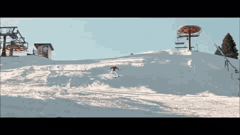 a person is skiing down a snow covered slope