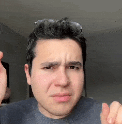 a man wearing sunglasses is making a funny face while making a funny face .