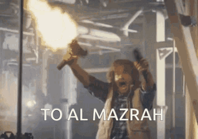 a man is holding a torch up in the air and says to al mazrah