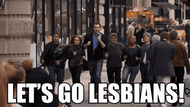 a group of people are running down a street with the words let 's go lesbians