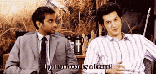 two men are sitting next to each other and one is saying `` i got run over by a lexus '' .