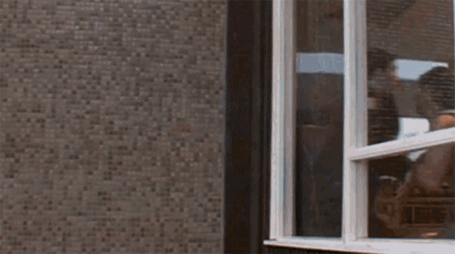 a man in a helmet is breaking a window