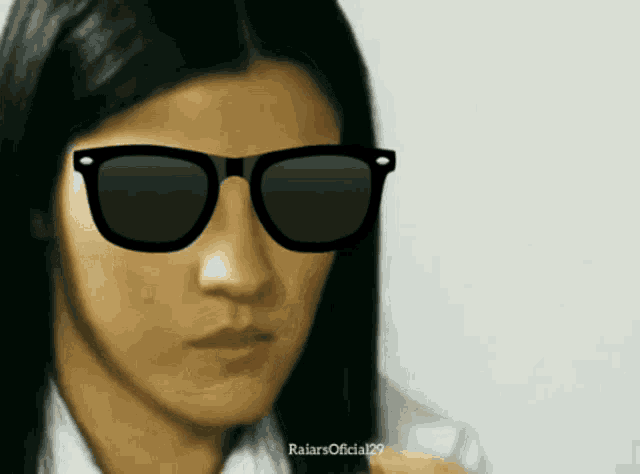 a woman wearing sunglasses has the word raiars on the bottom left