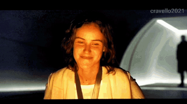 a woman is smiling in a dark room with the words cravello2021 at the bottom
