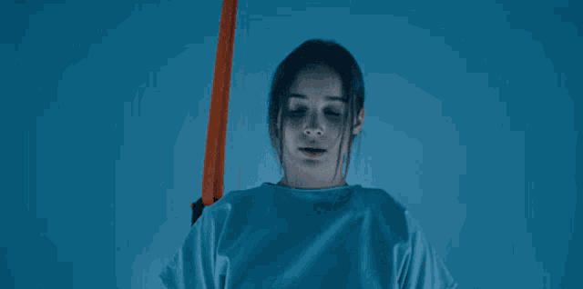 a woman in a surgical gown with the words here goes something behind her