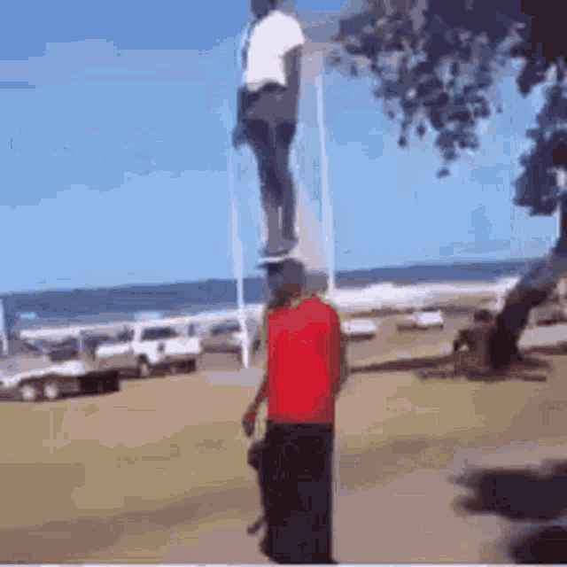 a man in a red shirt is standing next to a man in a white shirt