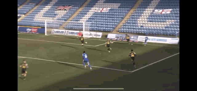 a soccer game is being played in an empty stadium with a sign that says ' skybet ' on it