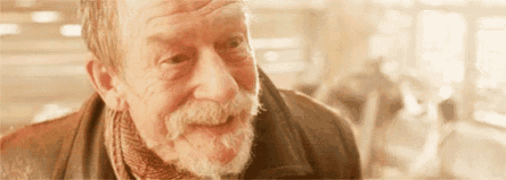 a man with a beard and mustache is smiling .
