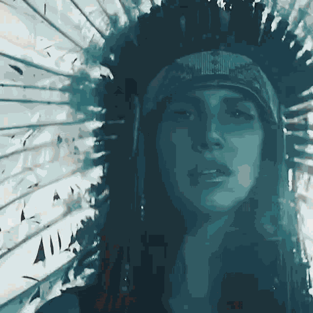 a woman is wearing a native american headdress and feathers