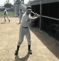 a man is swinging a baseball bat on a baseball field