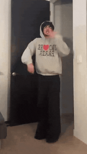a man wearing a hoodie that says i love new york on it