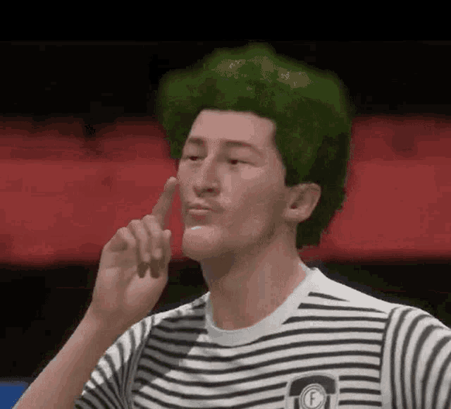 a man with green hair is wearing a striped shirt .