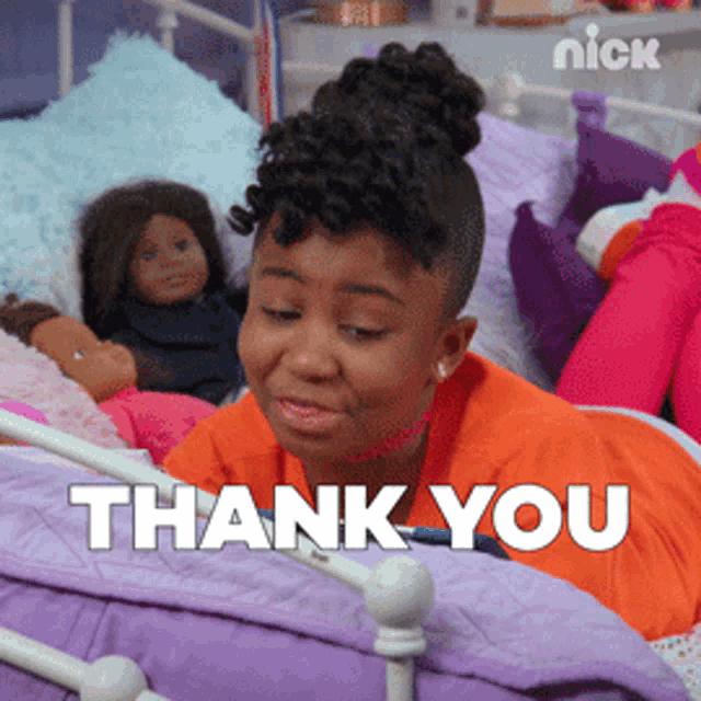 a girl laying on a bed with dolls and the words thank you