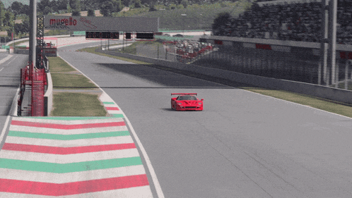 a red race car is driving down a race track with a sign that says museo