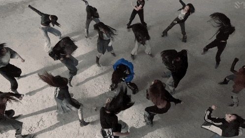 a group of women are dancing in a circle with one wearing a black shirt that says ' i love you ' on it