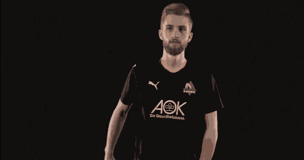 a man wearing a black shirt with aok written on it