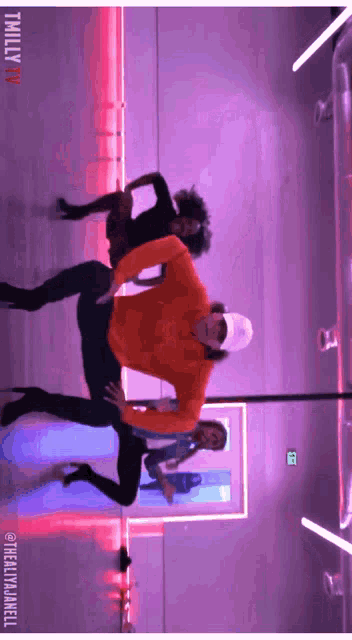 a group of people are dancing in a room with a sign that says thriller