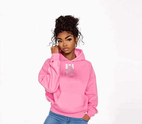 a woman wearing a pink hoodie that says dra