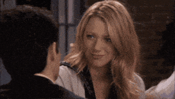 a man and a woman are looking at each other and the woman has red lipstick on her face