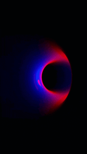 a red and blue light is coming out of a hole in the dark