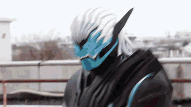 a person in a black and blue costume with a blue mask on their face