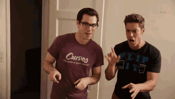 a man wearing a curves shirt is standing next to another man wearing a flip it shirt