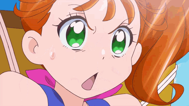 a girl with orange hair and green eyes is looking at the camera