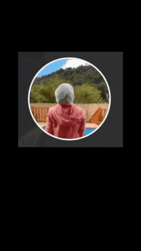 a person in a red hoodie is standing in a circle with two crowns on it .