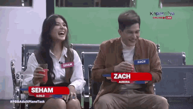 a man and a woman are sitting next to each other with their names on the screen