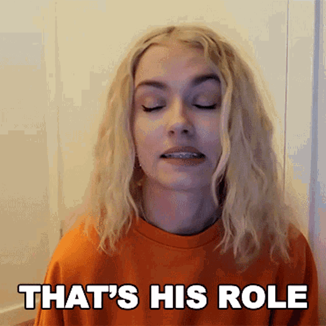 a woman with braces on her teeth is making a funny face and says that 's his role