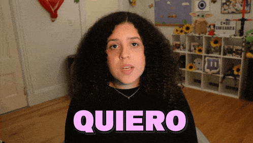 a girl with curly hair says quiero in pink letters