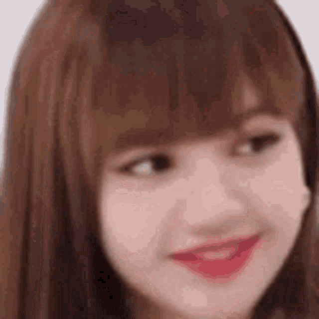 a close up of a woman 's face with long brown hair and red lipstick .