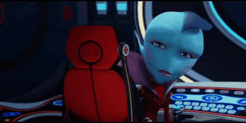 a blue alien is sitting in a red chair with a red cross on the back