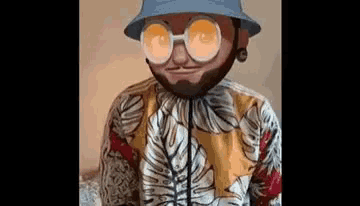 a man with a beard and sunglasses is wearing a bucket hat and a hawaiian shirt .