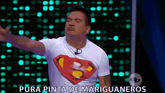 a man wearing a superman t-shirt with pura pinta de mariguaneros written on the bottom
