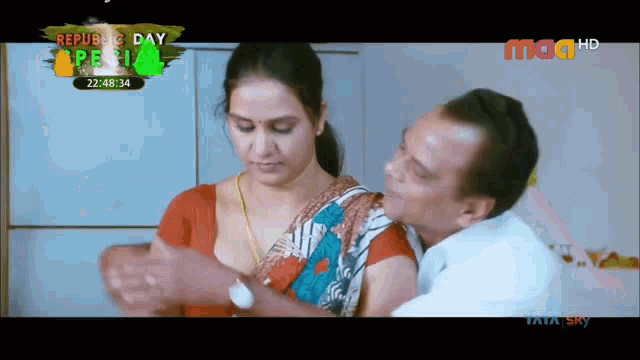 a man kisses a woman 's breast in a video that says republic day