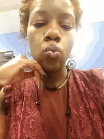 a woman is making a funny face with her hand