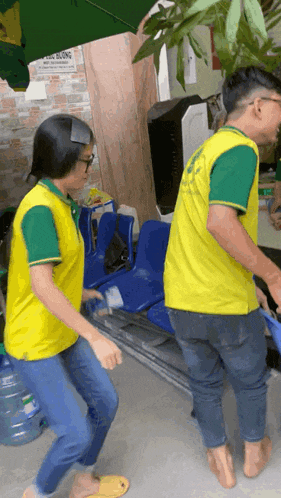 a man and a woman wearing yellow and green shirts are standing barefoot