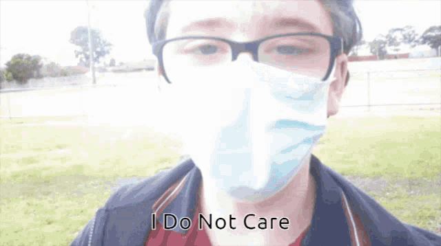 a man wearing a face mask and glasses says i do not care