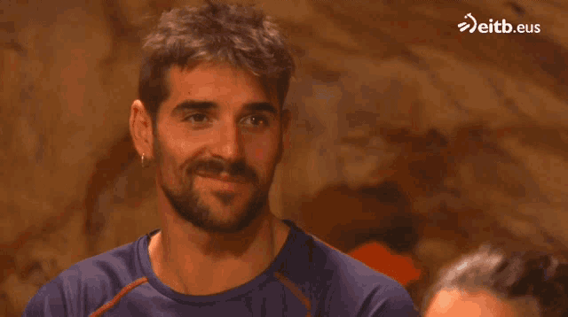 a man with a beard is smiling with eitb.eus in the corner